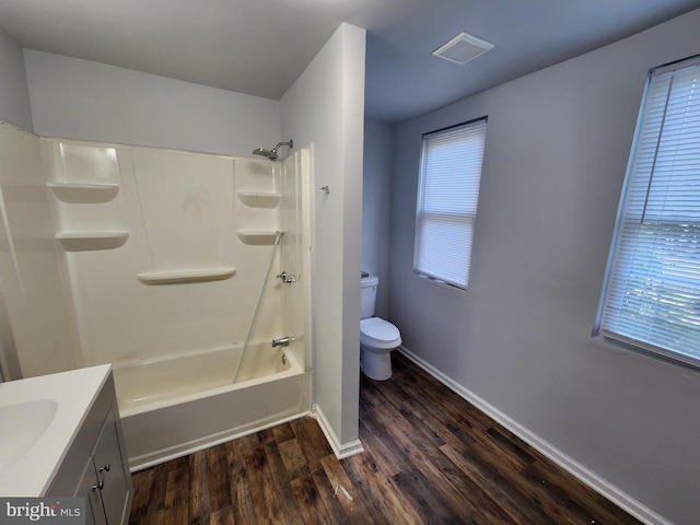 full bathroom featuring hardwood / wood-style floors, vanity, toilet, and shower / bathing tub combination