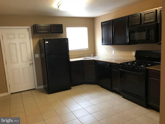 kitchen featuring sink, light tile patterned floors, and black appliances