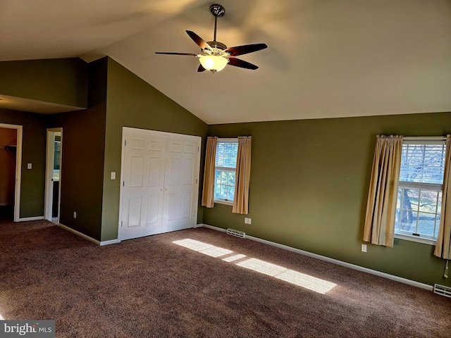 unfurnished bedroom with ceiling fan, a closet, carpet floors, and vaulted ceiling