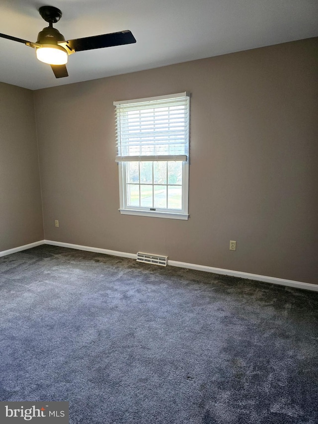 carpeted spare room with ceiling fan