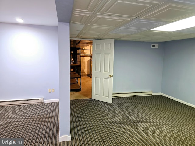 basement featuring baseboard heating and carpet flooring