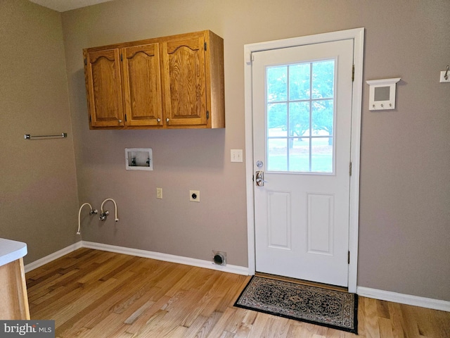 washroom with hookup for a washing machine, light wood-type flooring, gas dryer hookup, and electric dryer hookup