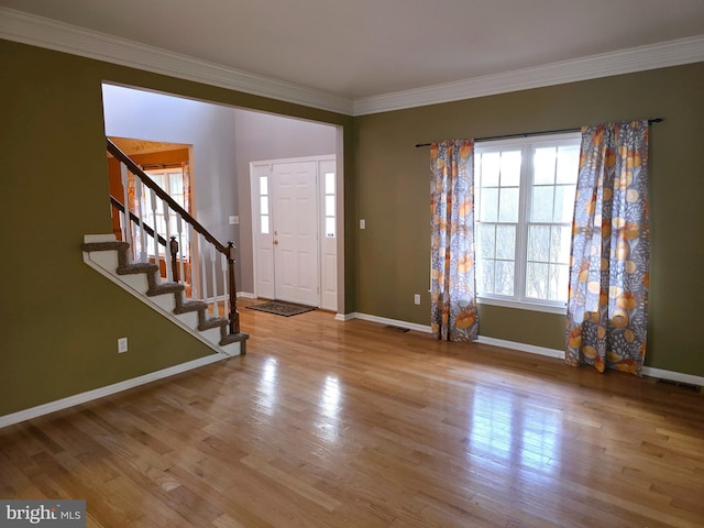 foyer featuring light hardwood / wood-style flooring and crown molding