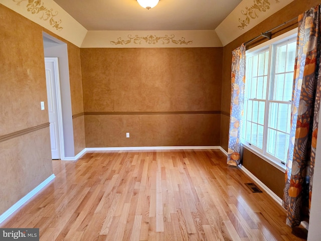 unfurnished room featuring light hardwood / wood-style flooring and plenty of natural light