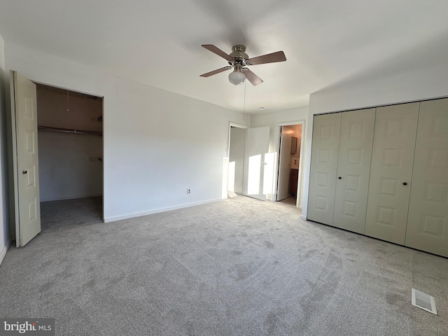 unfurnished bedroom with carpet floors, ceiling fan, and connected bathroom