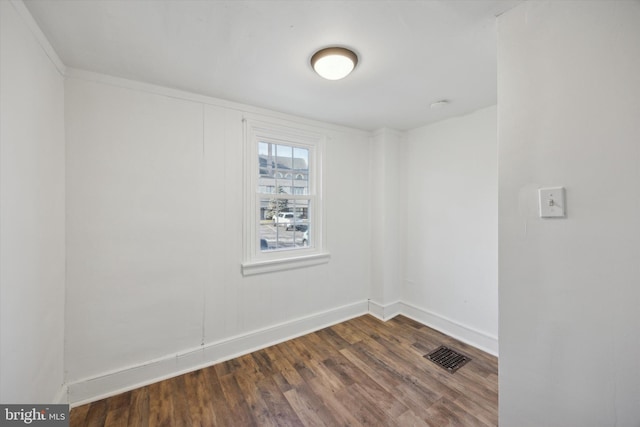 spare room featuring dark hardwood / wood-style floors