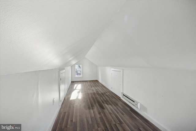 bonus room with a textured ceiling, dark hardwood / wood-style floors, lofted ceiling, and baseboard heating