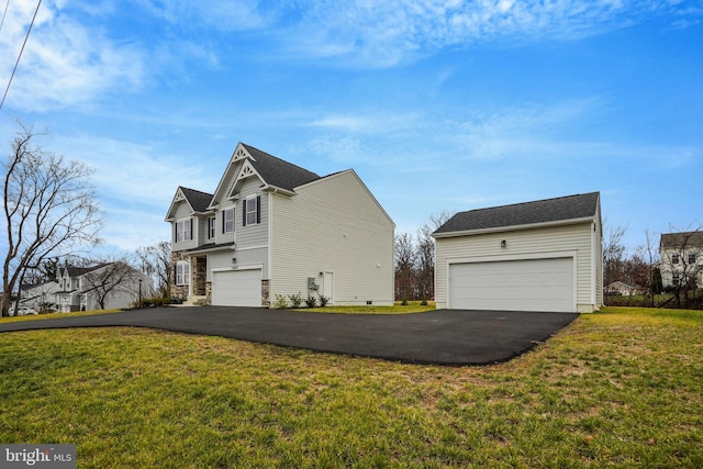 view of side of home with a yard and a garage