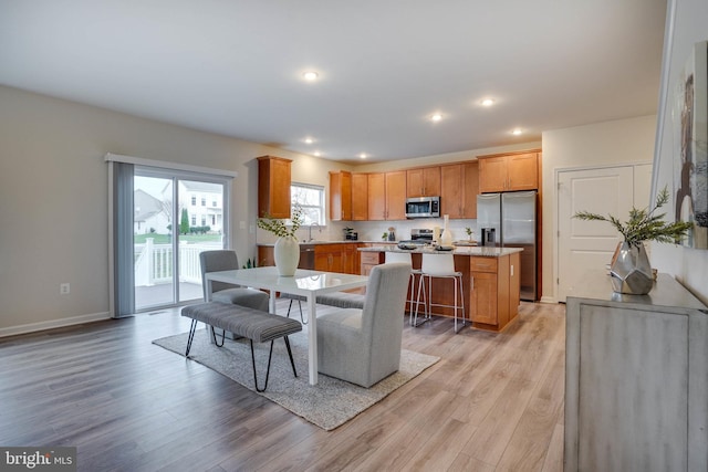 dining area featuring light hardwood / wood-style flooring and sink