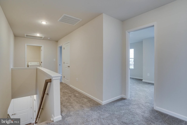 hallway with light carpet