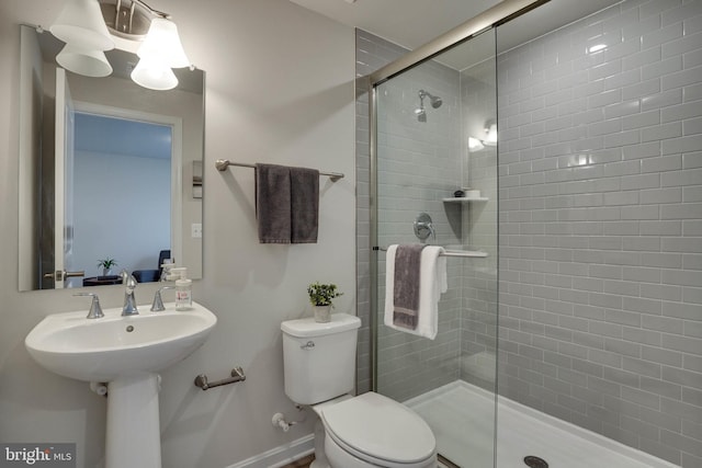 bathroom with toilet and an enclosed shower