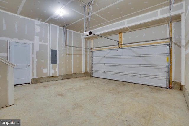 garage with electric panel and a garage door opener