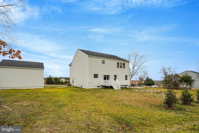 back of house with a lawn and a deck