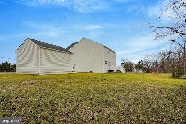 view of side of home with a lawn