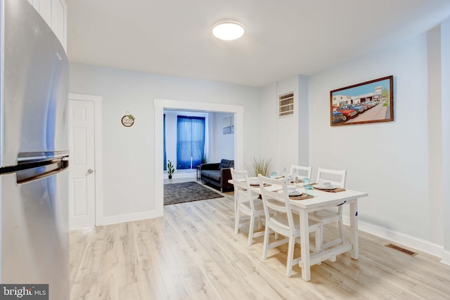 dining area with light hardwood / wood-style floors