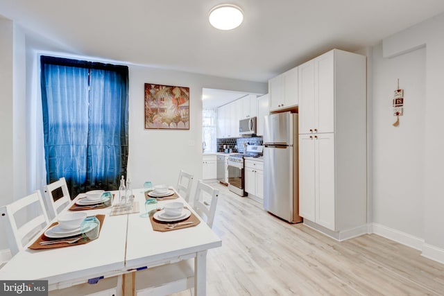 dining space with light wood-type flooring