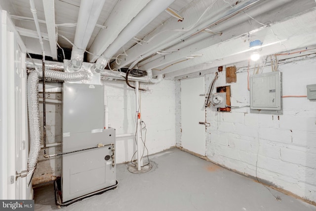 basement featuring heating unit and electric panel