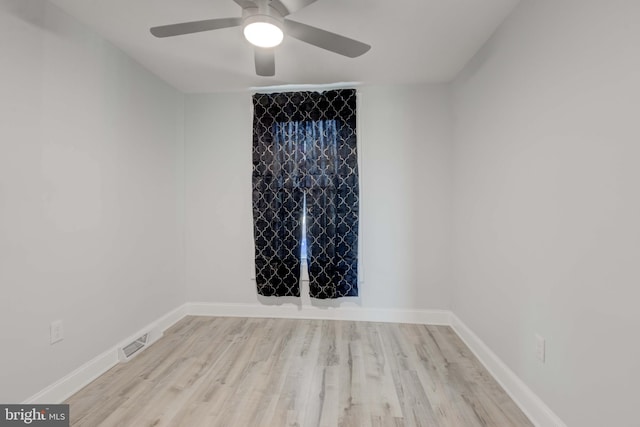 empty room with ceiling fan and light hardwood / wood-style flooring