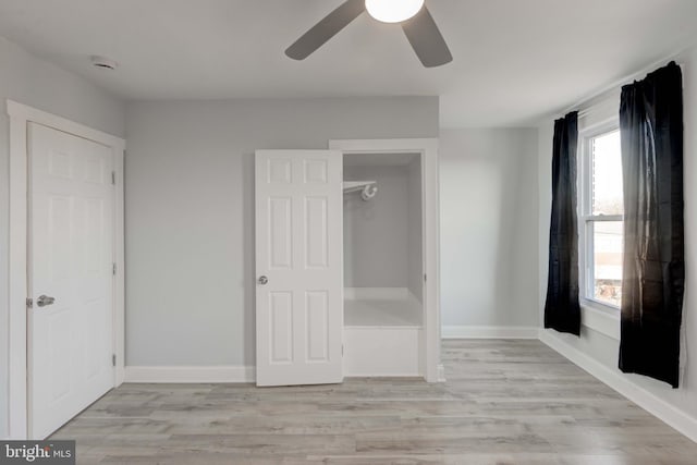 unfurnished bedroom with light wood-type flooring and ceiling fan