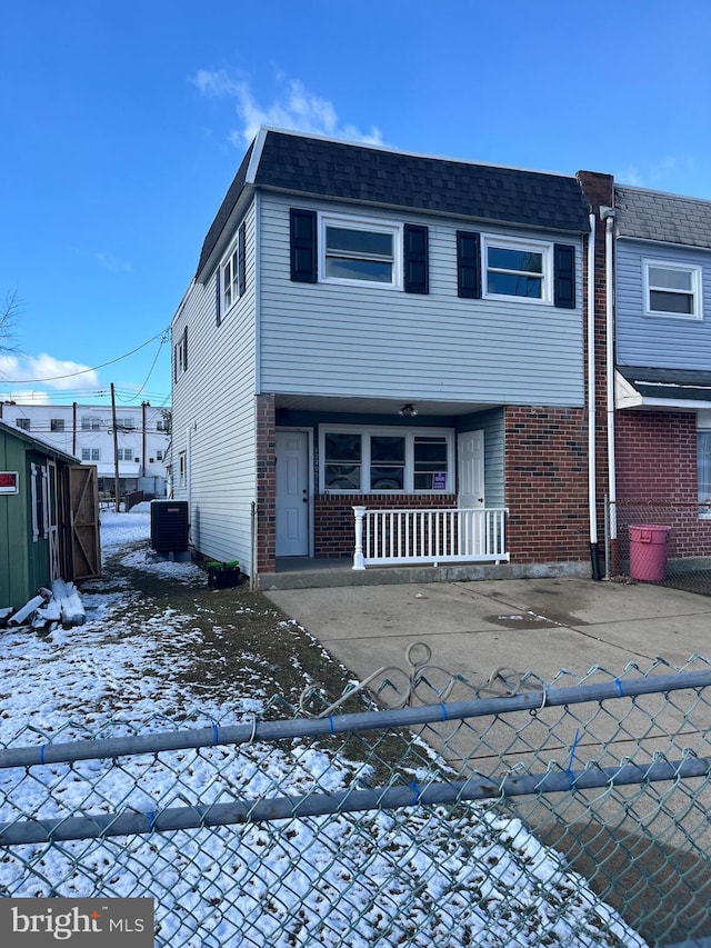 view of front of property featuring central AC unit and a porch