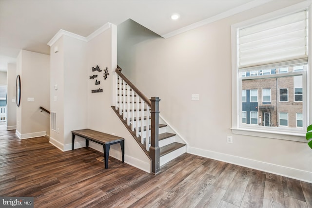 staircase with hardwood / wood-style flooring and ornamental molding