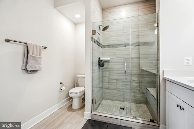 bathroom featuring hardwood / wood-style flooring, vanity, toilet, and an enclosed shower