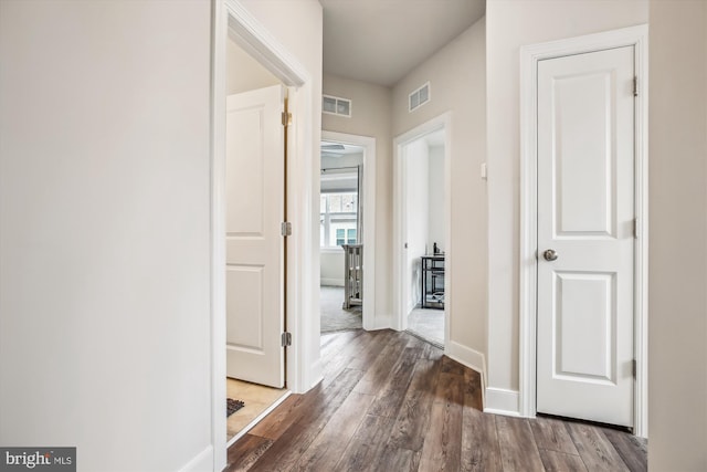 corridor featuring dark hardwood / wood-style flooring