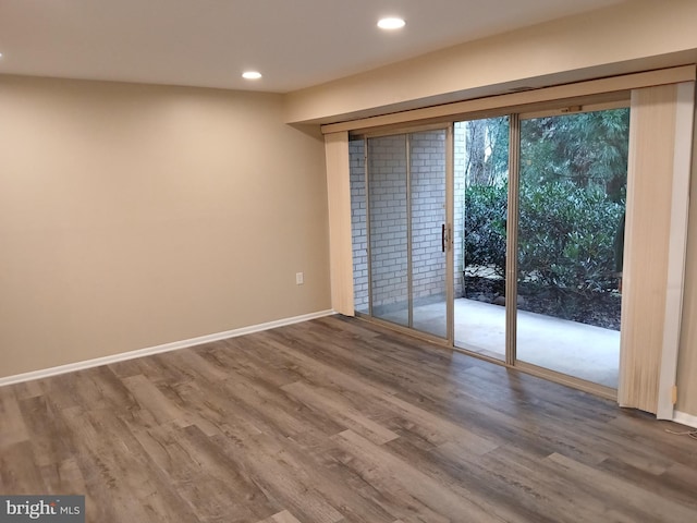 spare room with hardwood / wood-style floors