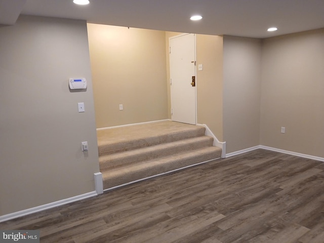 staircase featuring wood-type flooring