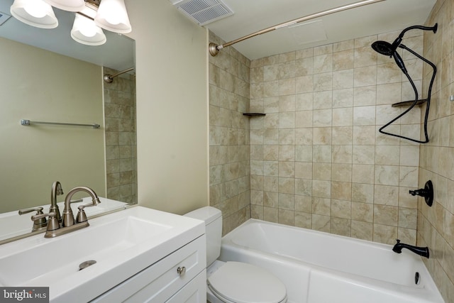 full bathroom with vanity, toilet, and tiled shower / bath