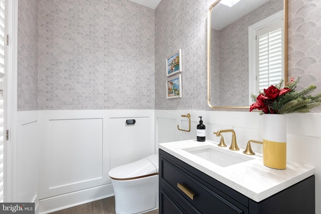 bathroom featuring hardwood / wood-style flooring, vanity, and toilet