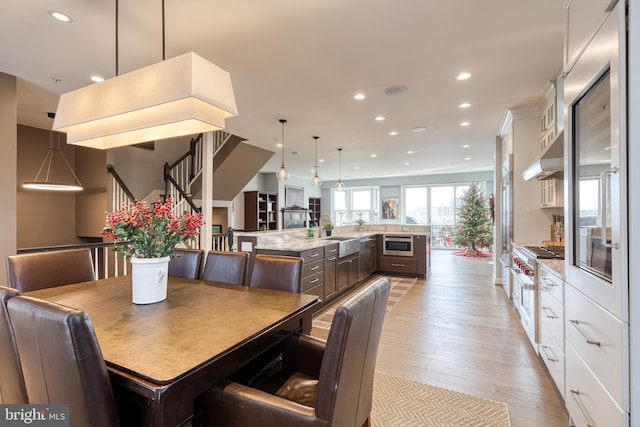 dining area with sink and light hardwood / wood-style flooring