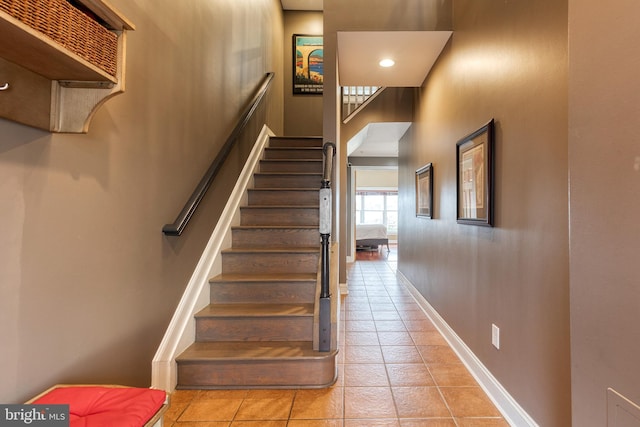 staircase featuring tile patterned floors