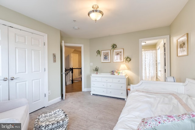 bedroom featuring light colored carpet and a closet