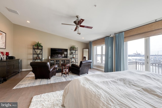 bedroom with lofted ceiling, access to outside, light hardwood / wood-style floors, and ceiling fan