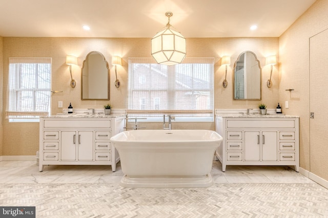 bathroom with a tub to relax in and vanity