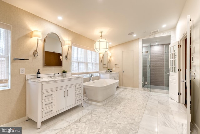 bathroom with vanity and separate shower and tub