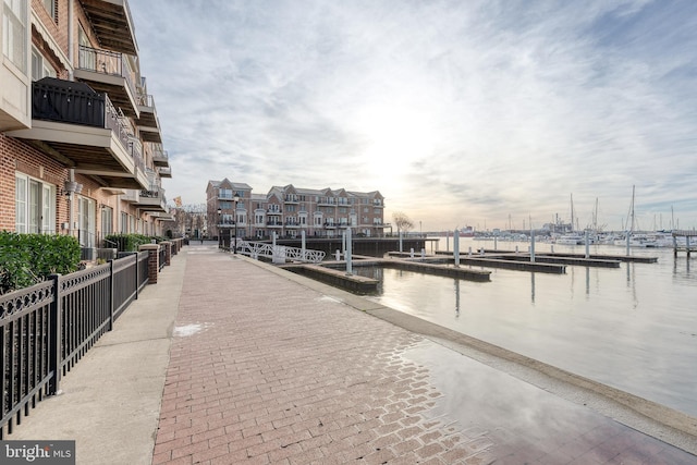 view of home's community featuring a boat dock and a water view