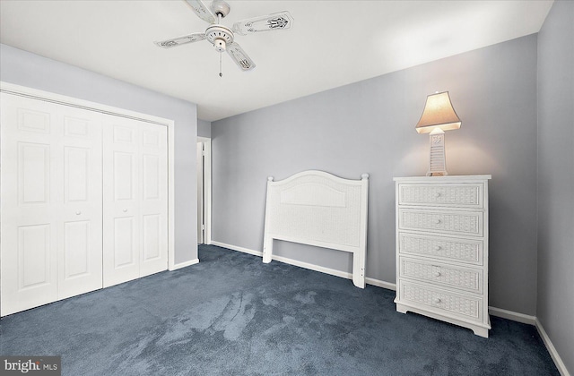 unfurnished bedroom with a closet, dark carpet, and ceiling fan