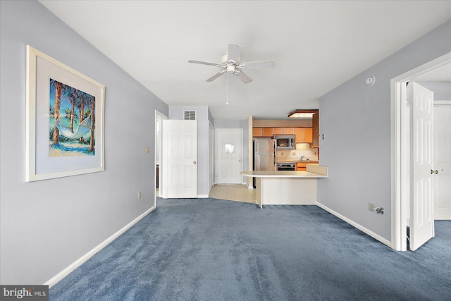 unfurnished living room with dark carpet and ceiling fan