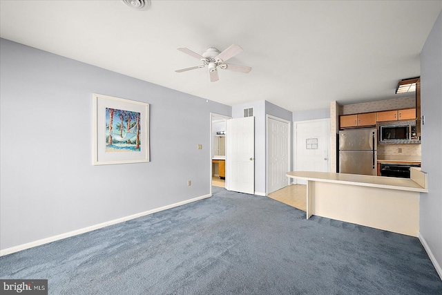 kitchen with backsplash, ceiling fan, light colored carpet, and stainless steel appliances