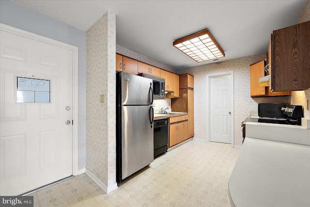 kitchen with black appliances, ventilation hood, and sink