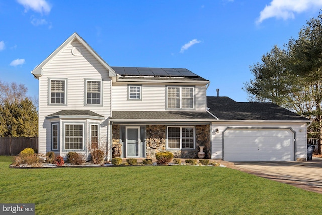 view of front property with solar panels, a garage, and a front lawn