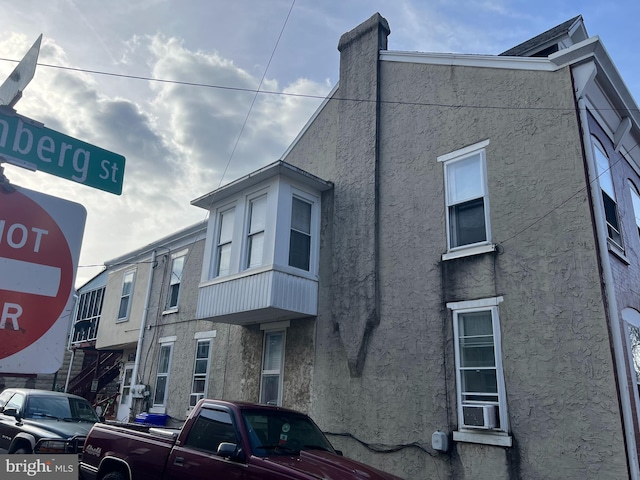 view of side of home featuring cooling unit