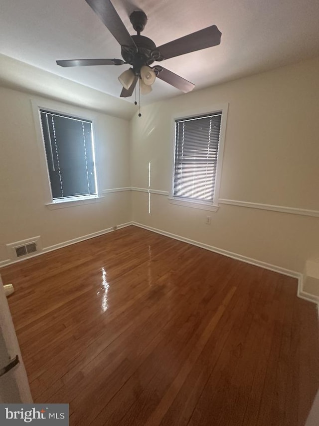 unfurnished room with hardwood / wood-style floors and ceiling fan