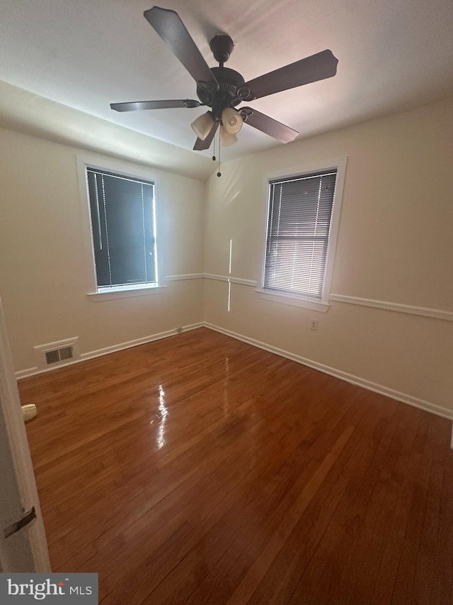 spare room with hardwood / wood-style flooring and ceiling fan