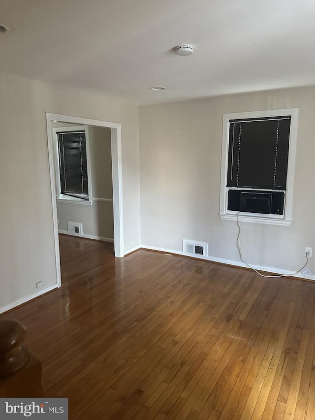 unfurnished room featuring dark hardwood / wood-style floors