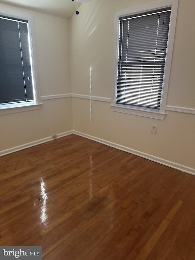 unfurnished room featuring wood-type flooring