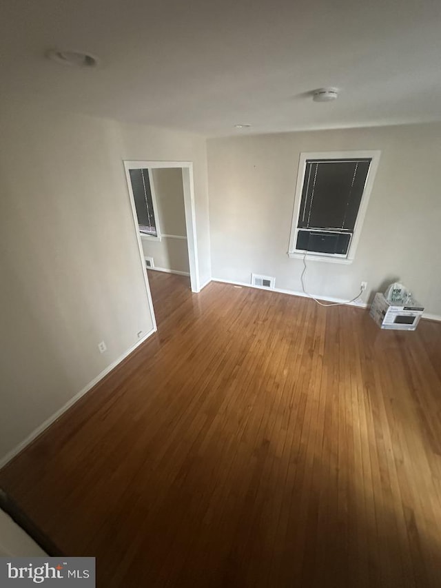 unfurnished room with hardwood / wood-style floors