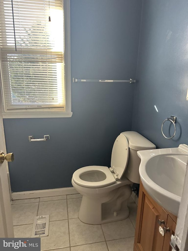 bathroom featuring tile patterned floors, vanity, and toilet